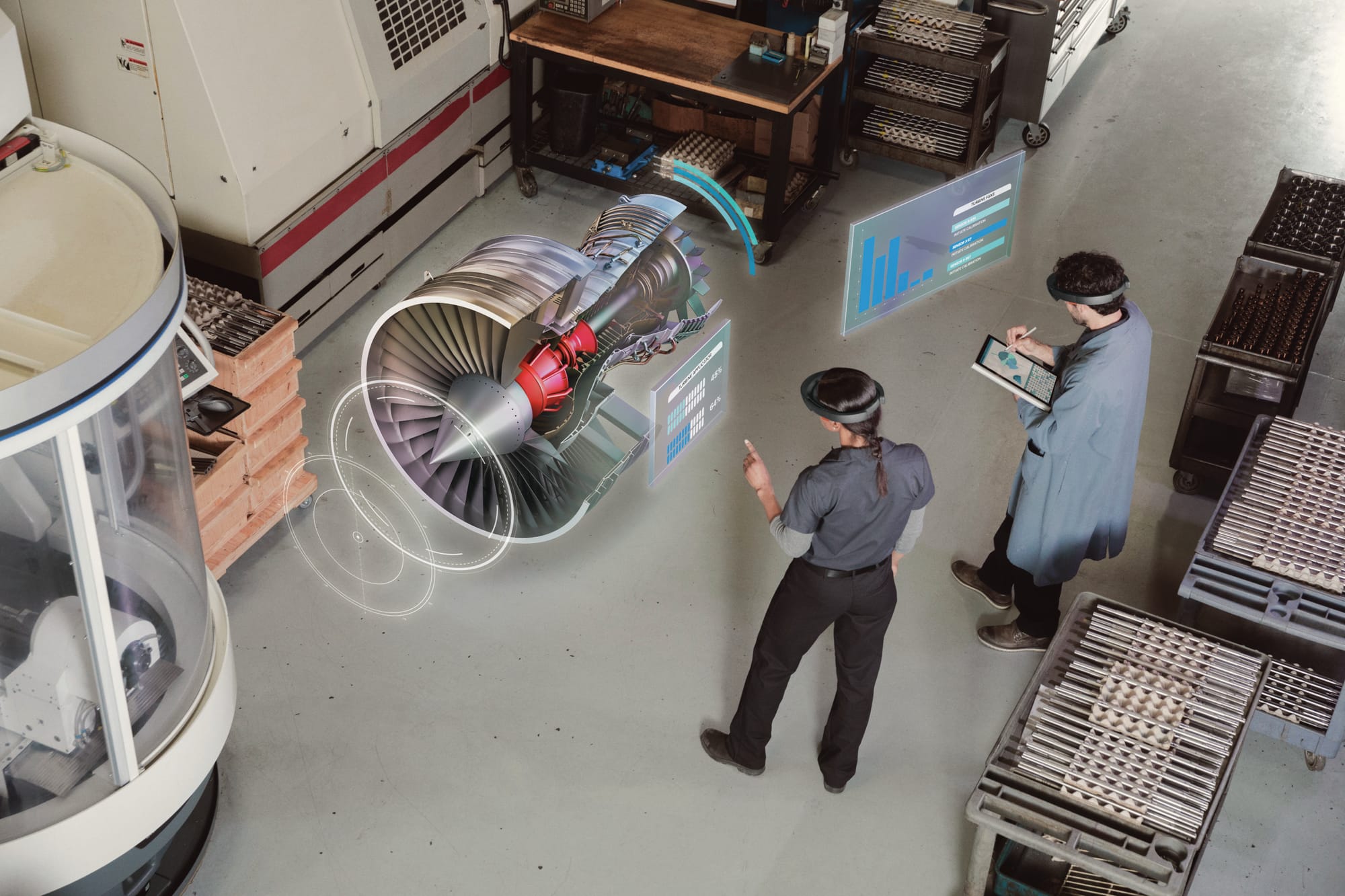 Overhead view of two engineers using Microsoft HoloLens to visualize a jet engine 